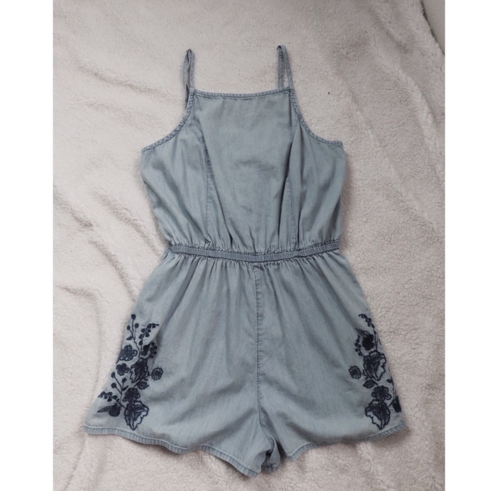 A light blue romper with a beautiful design in the front